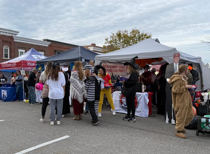 Costumed visitors gathered around the party booth at Fright on Franklin