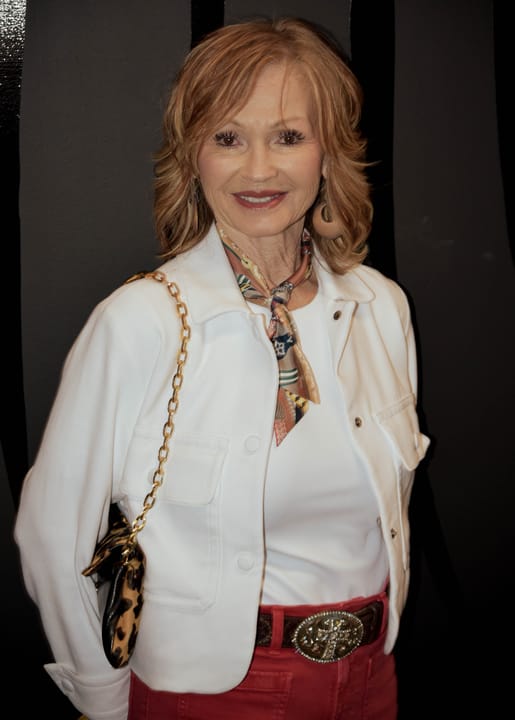 A guest in a white jacket posing for a portrait
