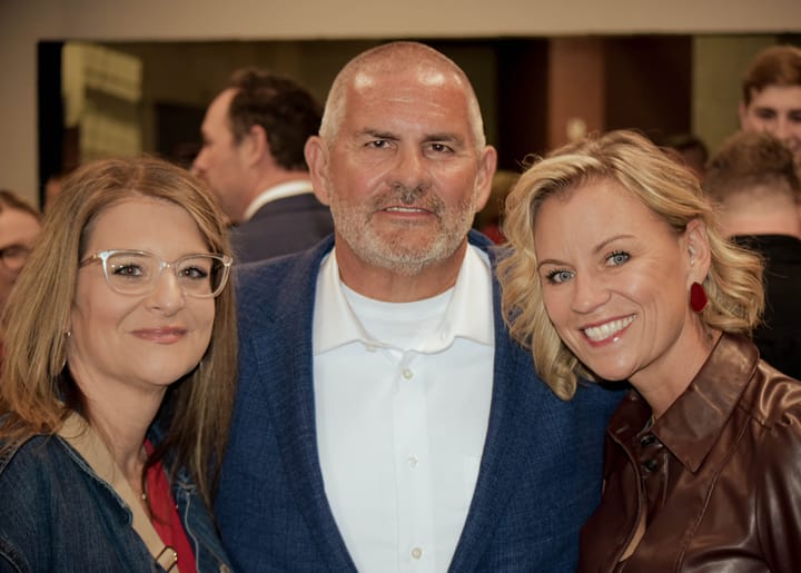 Three guests posing together in the event concourse