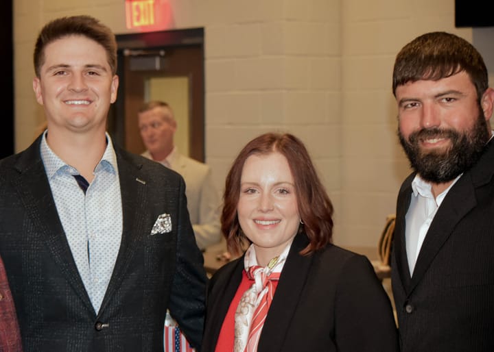 Three guests posing together beside the concourse doors
