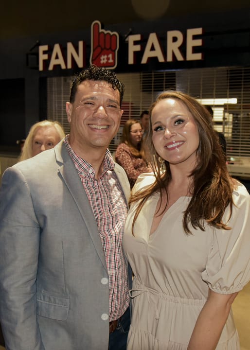 Two guests posing together near a concession area