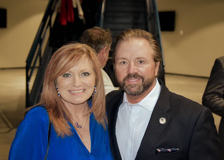 Two guests posing in a bright blue top and dark blazer