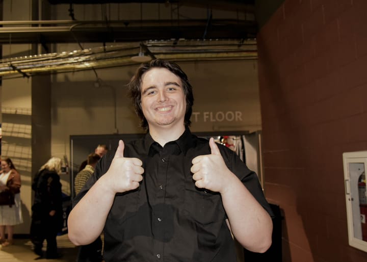 A smiling guest giving two thumbs up