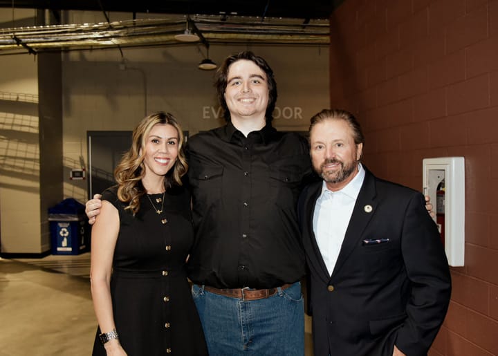 Three guests standing together on the event floor
