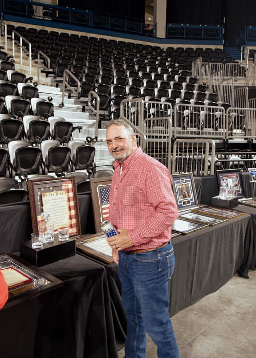 A guest in a pink shirt standing beside the auction display
