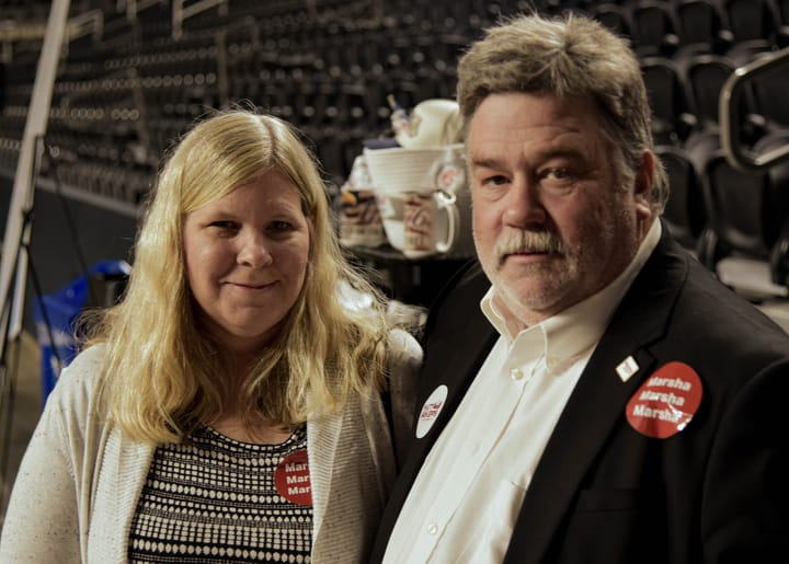 Two guests posing together on the arena floor