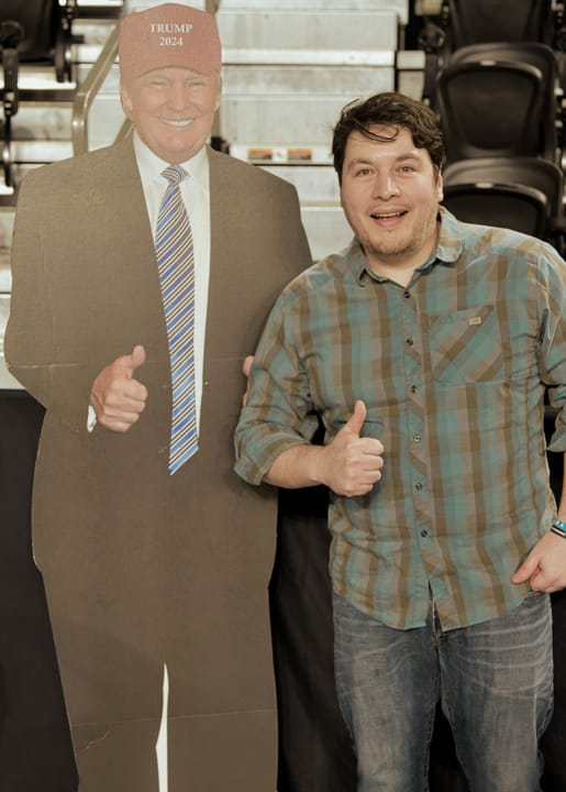 A guest giving a thumbs up beside a cardboard figure