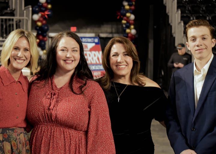 Four guests posing together on the event floor