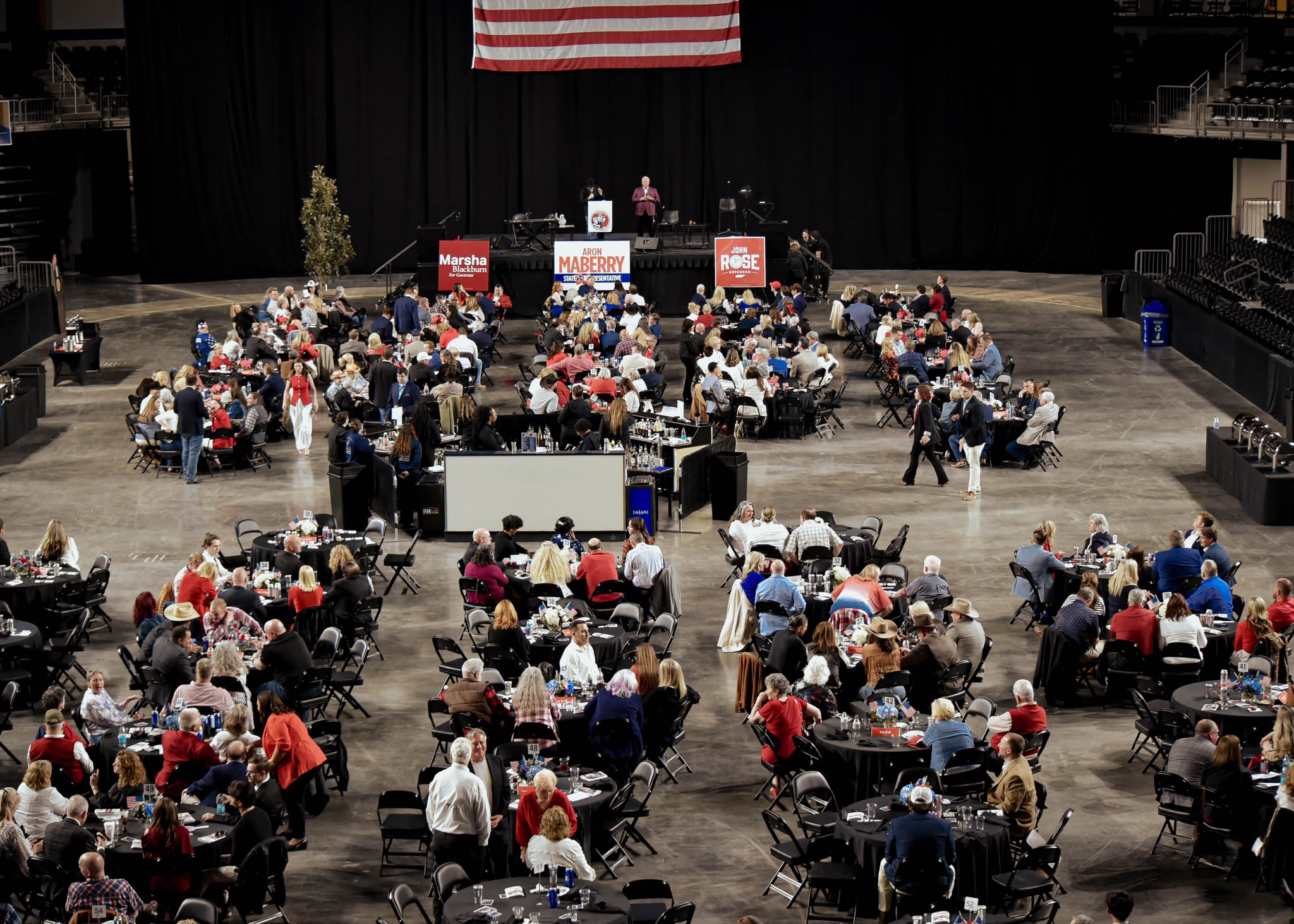 Guests gathered for LRDD 2026, with dinner tables and the stage beneath an American flag