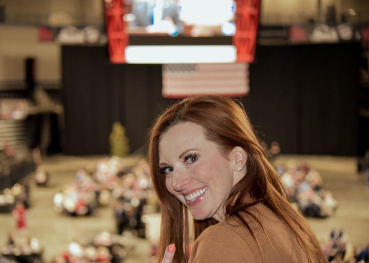 A smiling guest turning toward the camera above the event floor
