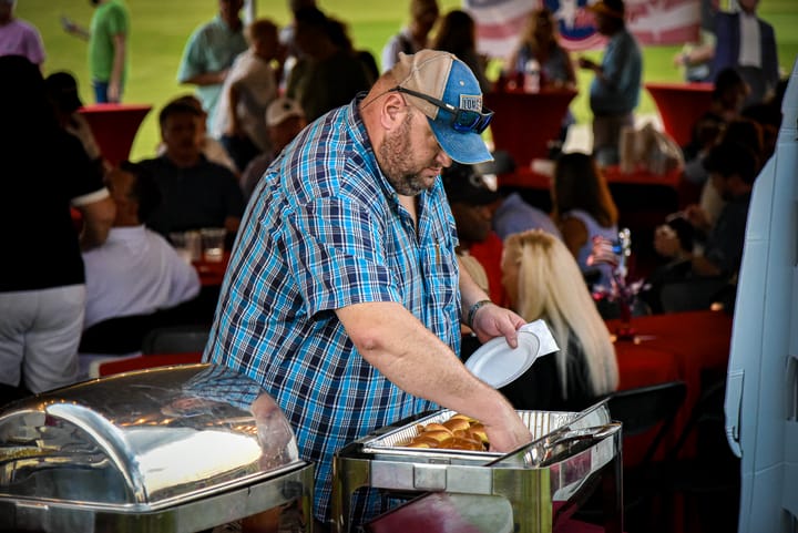 A guest serving food at the gathering