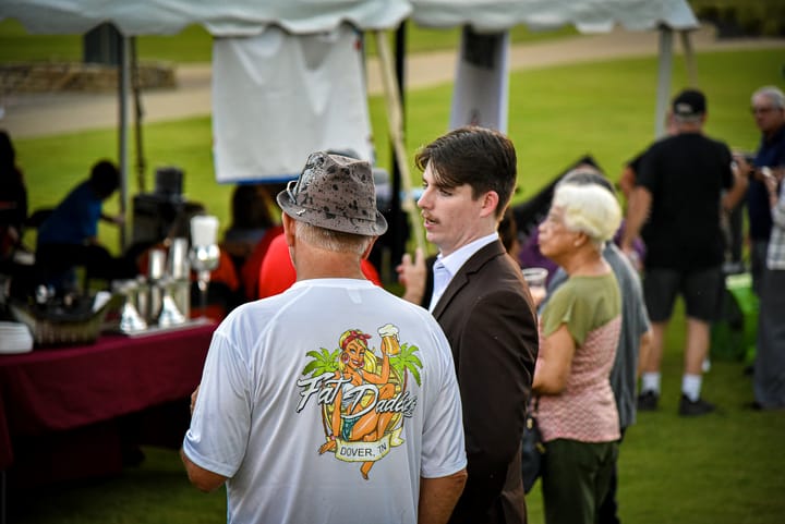 Guests in conversation beneath the tent