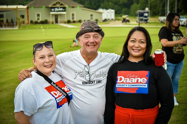 Another portrait of three guests on the lawn