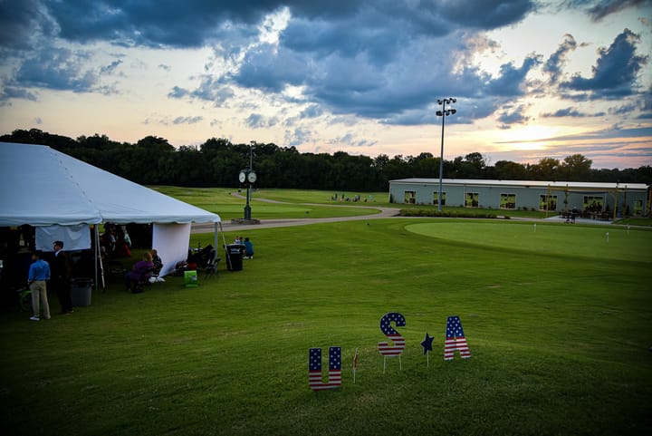 The tent and lawn beneath an evening sky