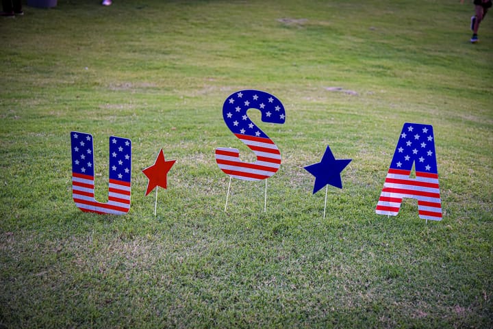 Red, white, and blue USA decorations on the lawn