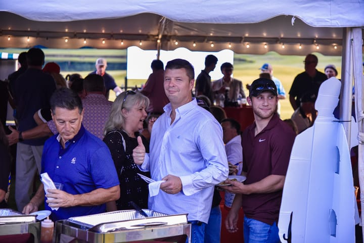 Guests enjoying the food service under the tent