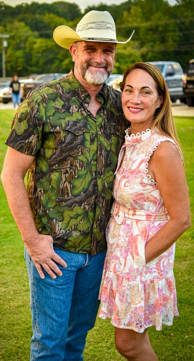 Two guests posing, one wearing a cowboy hat