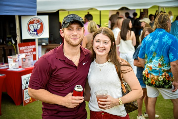 Two guests smiling together in front of the gathering