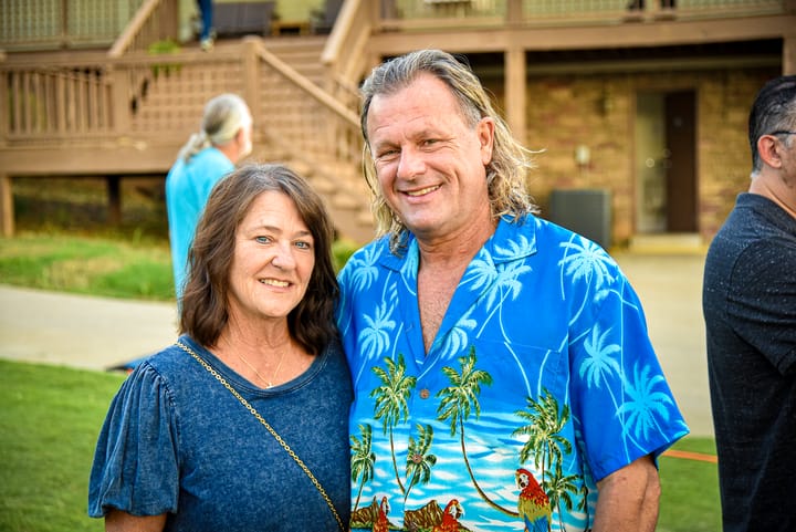 Two guests posing near the venue building