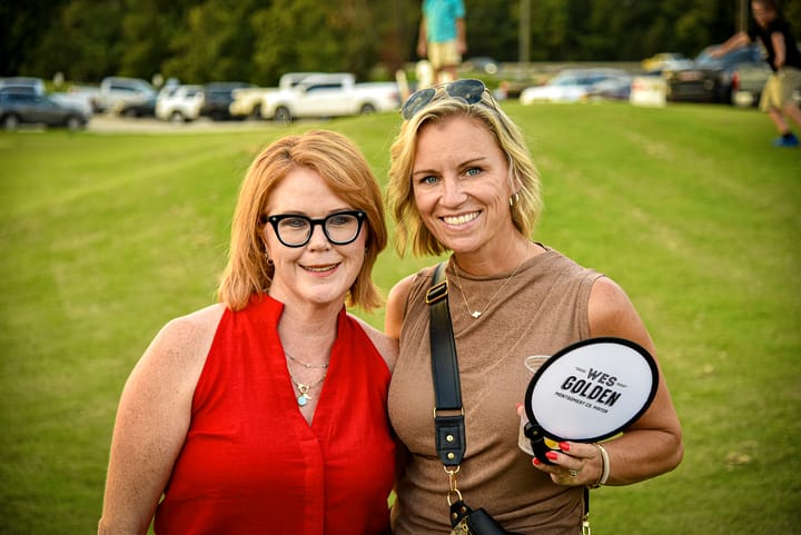 Two guests posing together on the lawn