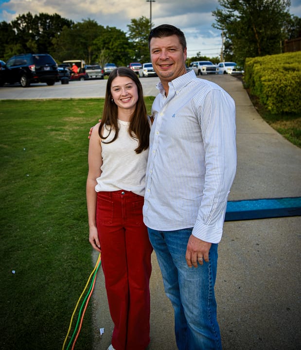Two guests standing together beside the lawn